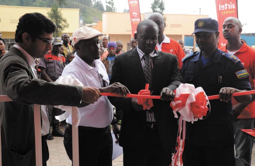 Bagyirisha (second, right) and Nsengayuimva (right) are joined by Airtel staff to  launch the service centre.