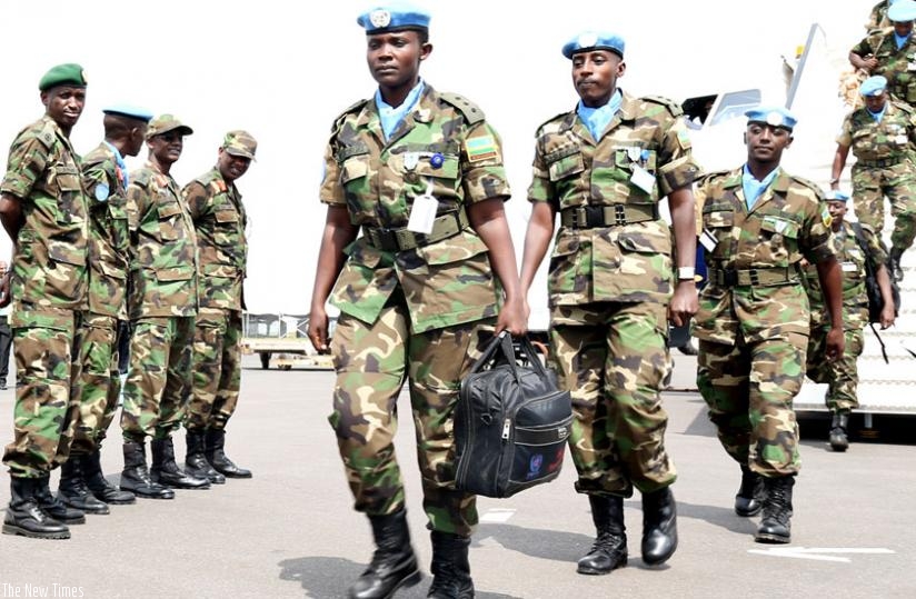 RDF peacekeepers alight from a plane at Kigali International Airport yesterday. (John Mbanda)