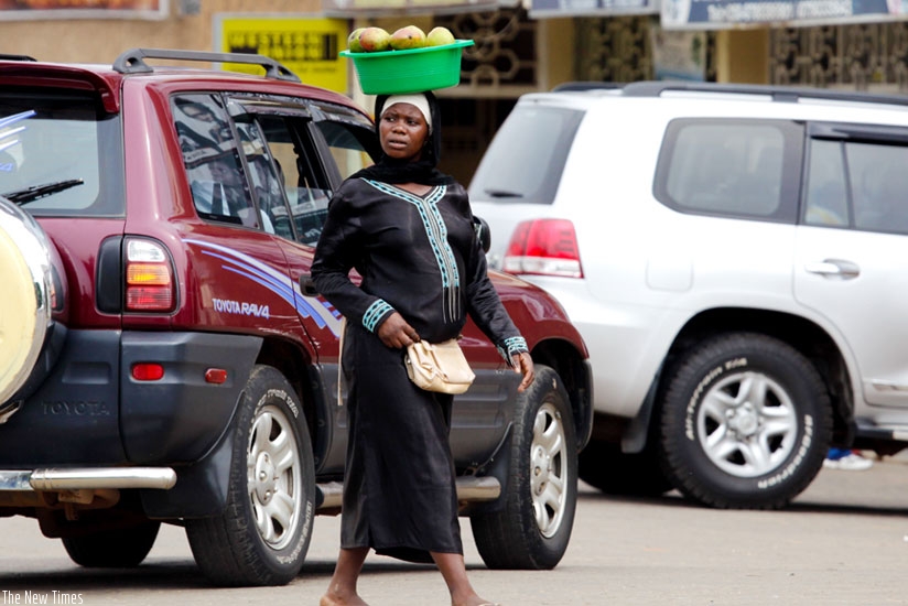 A street vendor in downtown Kigali. Some vendors move with polythene bags concealed in other bags and only use them to package for a buyer. (T. Kisambira)