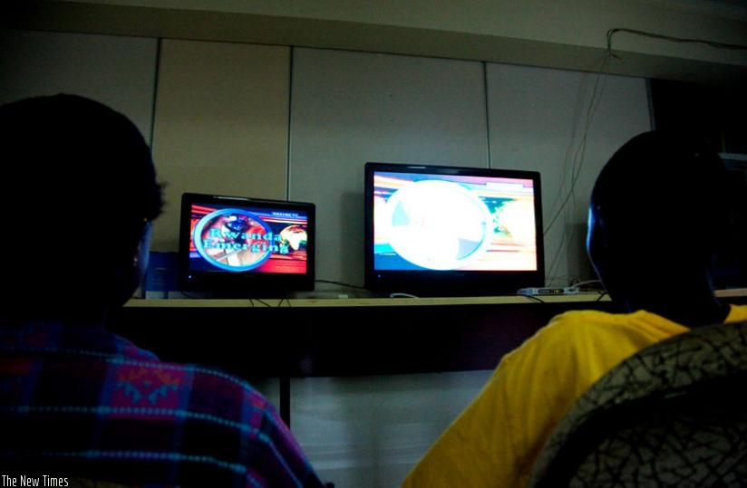 People watch television. Viewers say local stations are dominated by foreign content, which media owners say is cost-efficient. (File)