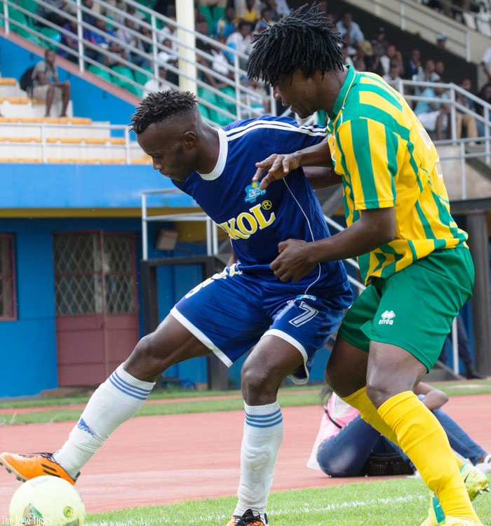 Rayon Sports striker Peter Otema (left) shields the ball against a Panthere defender on Sunday at Amahoro stadium. (Timothy Kisambira)
