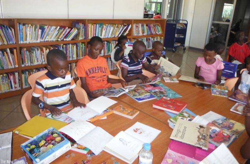 Children read books in the library. The reading culture in Rwanda is still low. (Dennis Agaba)
