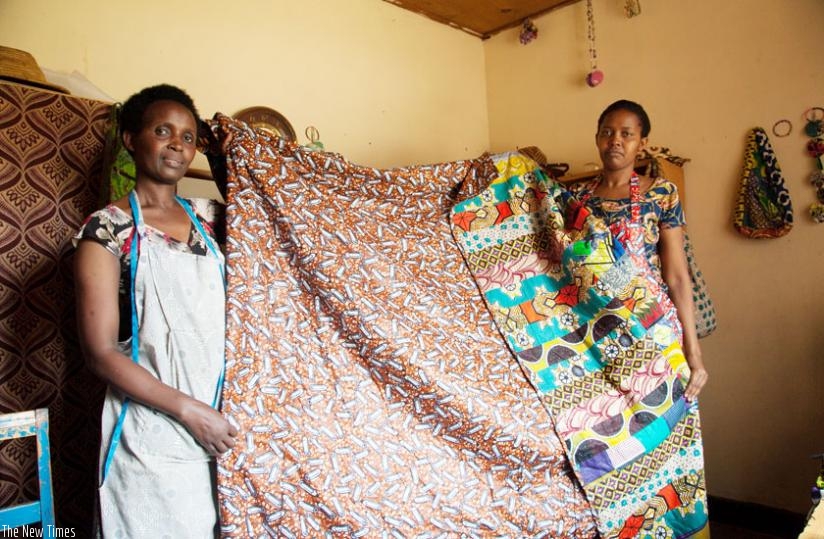 The ladies show a bedspread they made in Kitenge material (Faustin Niyigena)