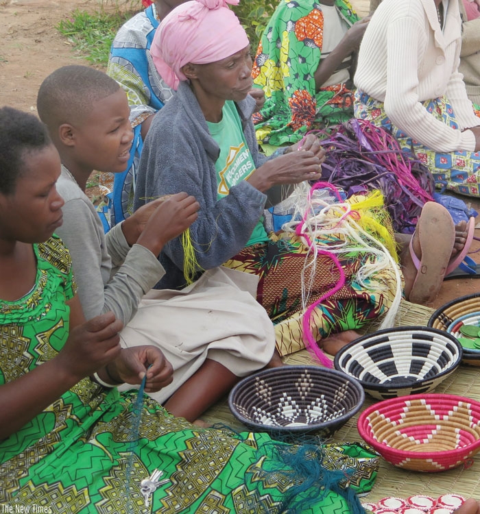 Members of Berwa Womenu2019s Association, a handicraft-making group in Kamusenyi, Byimana in Ruhango District, make crafts. The new initiative will train women like these ones to enhance their skills. 