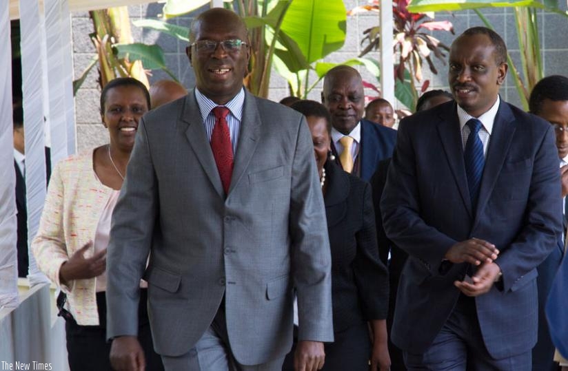 Prime Minister Anastase Murekezi (L) chats with EAC Secretary General Richard Sezibera( R) at Serena  Hotel yesterday after delivering his opening remarks.(Timothy Kisambira)