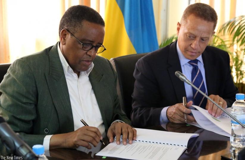Education minister Silas Lwakabamba (L) and Nicholas Nesbitt, the General Manager, IBM East Africa during the signing ceremony yesterday. (John Mbanda)