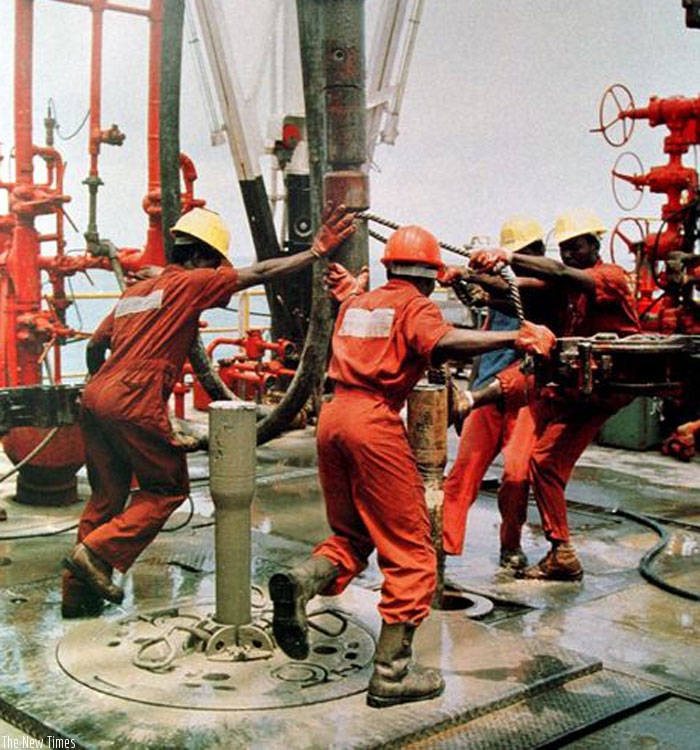 Workers operate an oil rig. Regional firms need to do more to benefit from opportunities in the oil sector.