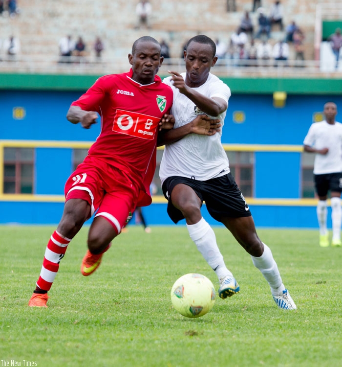 APR midfielder Jean-Claude Iranzi, right, battles with a Liga Desportiva de Maputo opponent at Amahoro stadium two weeks ago. (Timothy Kisambira)