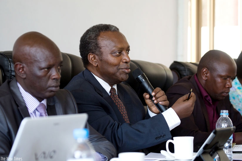 PAC chair Juvenal Nkusi (C) asks PS Sayinzoga a question yesterday. (Timothy Kisambira)