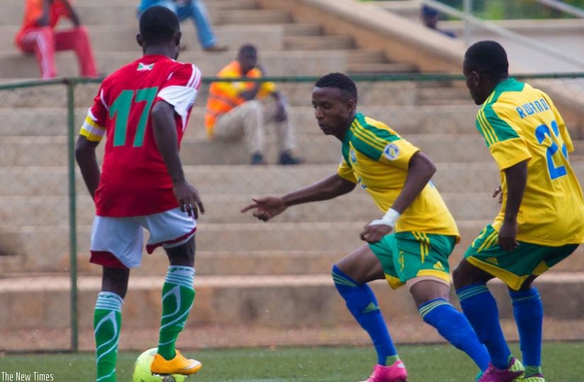 Amavubi defender Emery Bayisenge (R) closes down Burundi striker Cedric Amissi during a friendly game last December. Rwandau2019s last game was against Tanzania in January. (Timothy Kisambira)