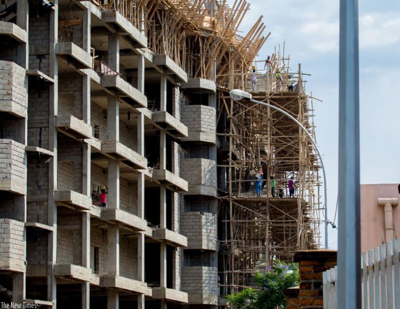 Workers at a construction site in Kimihurura yesterday. (Timothy Kisambira)