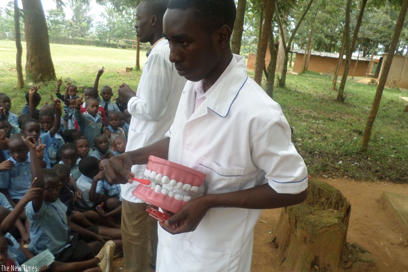 A dental medic demonstrates to pupils of Groupe Scolaire Nyamata Catholique, Bugesera District, how to brush teeth last year. (File)