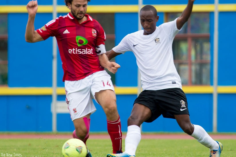 Iranzi Jean-Claude Iranzi of APR (right) brawls for the ball with Hossam Ghaly Al Ahly. (Timothy Kisambira)