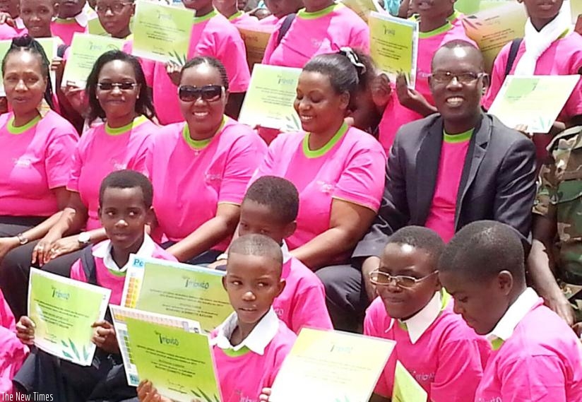 Some of the girls show their certificates in a group photo with Imbuto officials. Courtesy.