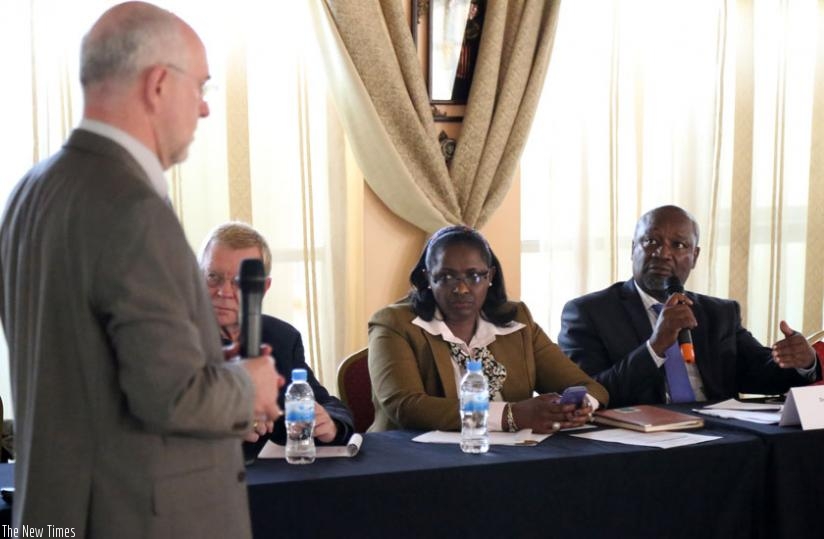 Klaus Wittkuhn (L) from Performance Design International listens to Gasamagera (R) during the training yesterday. Looking on, second right, is Mugabo. (John Mbanda)