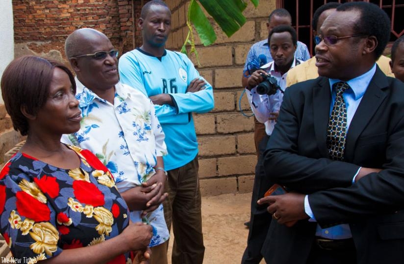 Dr Ndagijimana (R) speaks to a family in Muhima Sector that was sampled in the DHS data collection exercise. (Doreen Umutesi)