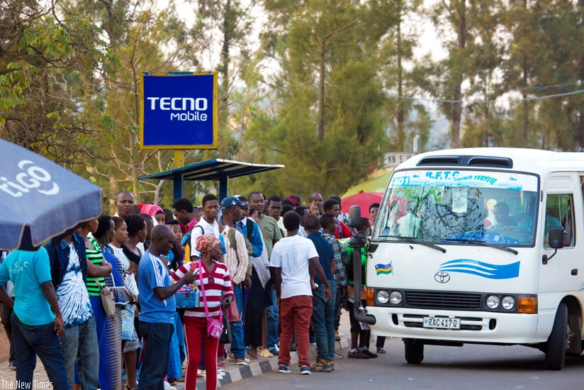  Passengers await buses along a street near Kigali Central Prison in downtown Kigali yesterday.  (All photos by Timothy Kisambira)