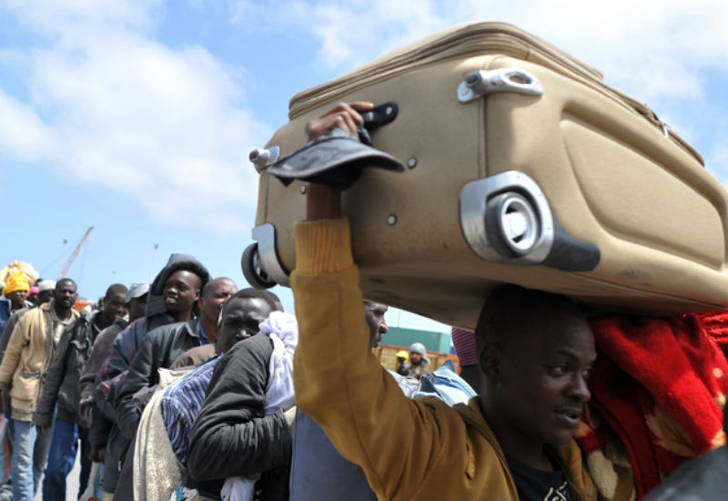 More than 1000 mainly African migrants queue at the port in Misrata, Libya waiting to board an International Organisation of Migration ship on May 4, 2014. Agencies