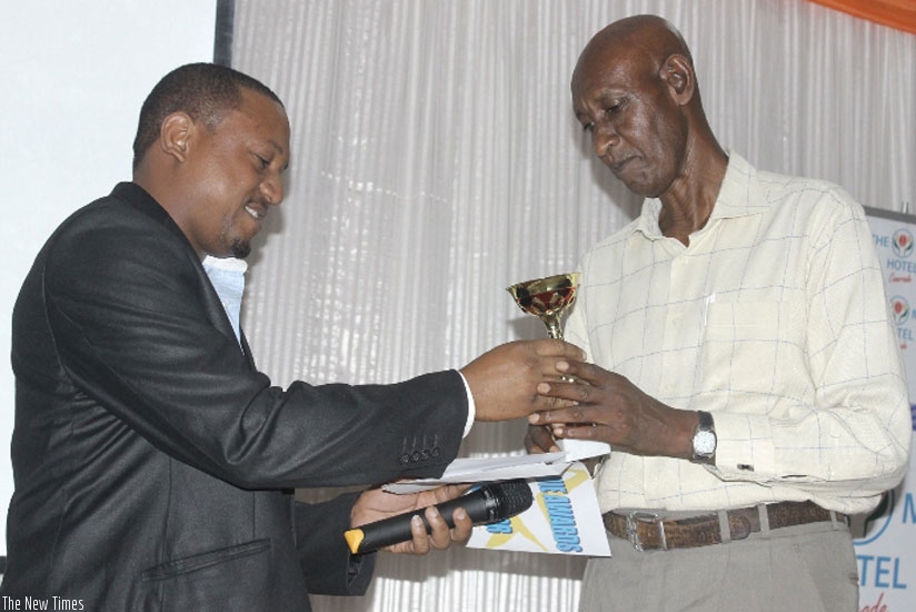 Best Old Actor Eugene Nkota (in white shirt) receiving his award.