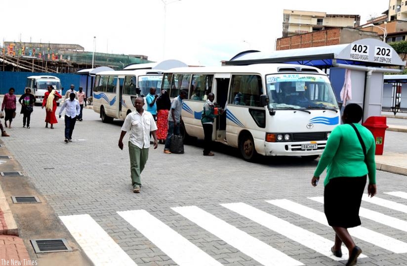 Passengers at the new bus terminal yesterday.  Both passengers and drivers are optimistic the new terminal will help ease public transport in downtown Kigali. (J. Mbanda)