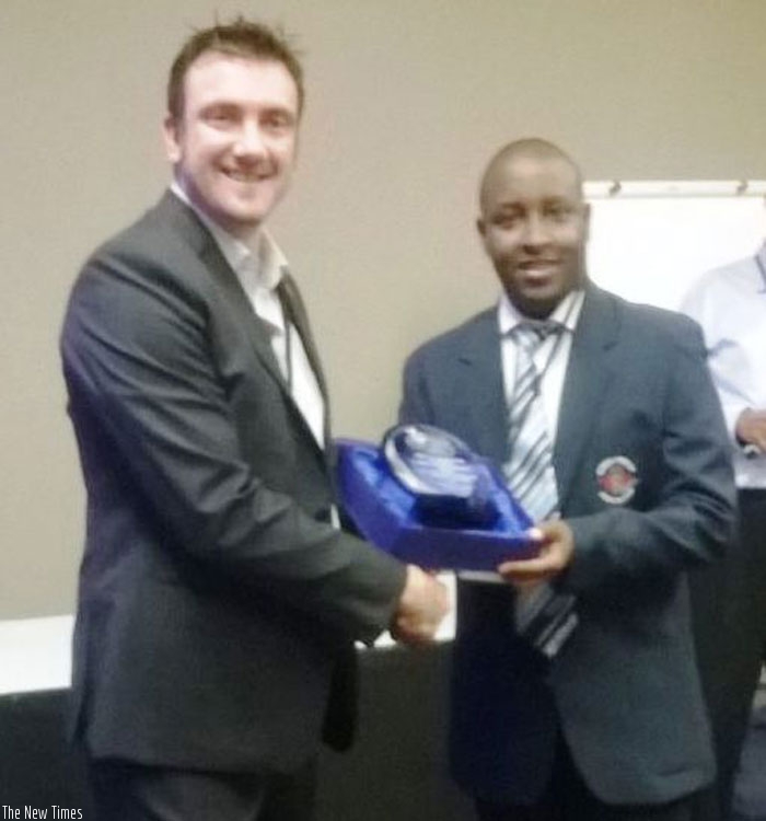 RCA boss Charles Haba (R) receives the award from ICC Global Development Manager Tim Andersen.
