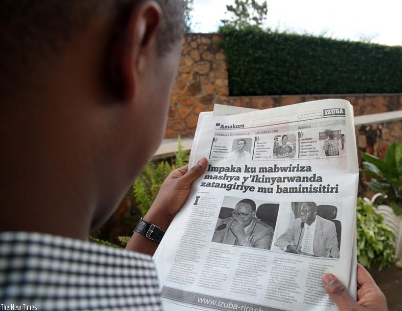 A man reads a vernacular newspaper that recently reported on the changes in Kinyarwanda language. (File)