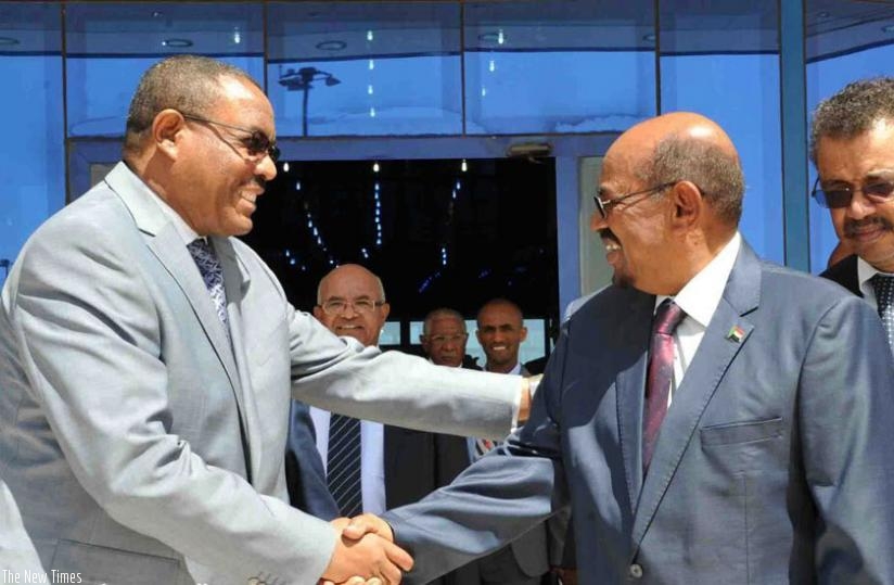 Ethiopian Prime Minister Desalegn, shakes hands with President Bashir (R) after the signing ceremony  in Khartoum on Monday. (Athan Tashobya)