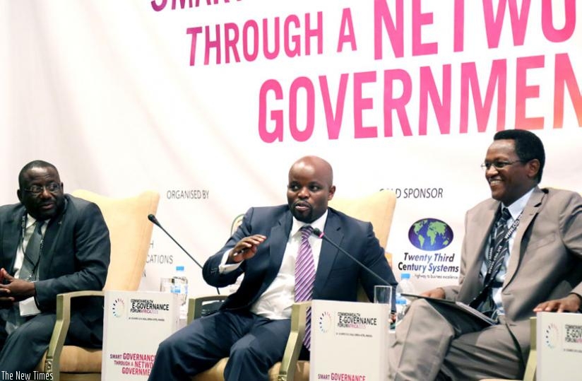 Nsengimana (C) speaks at  Electronic Governance Forum in Kigali, yesterday, Uganda's ICT State Minister William Nyombi and Burundi's Telecommunications Minister Tharcisse Nkezabahizi looks on. (John Mbanda)