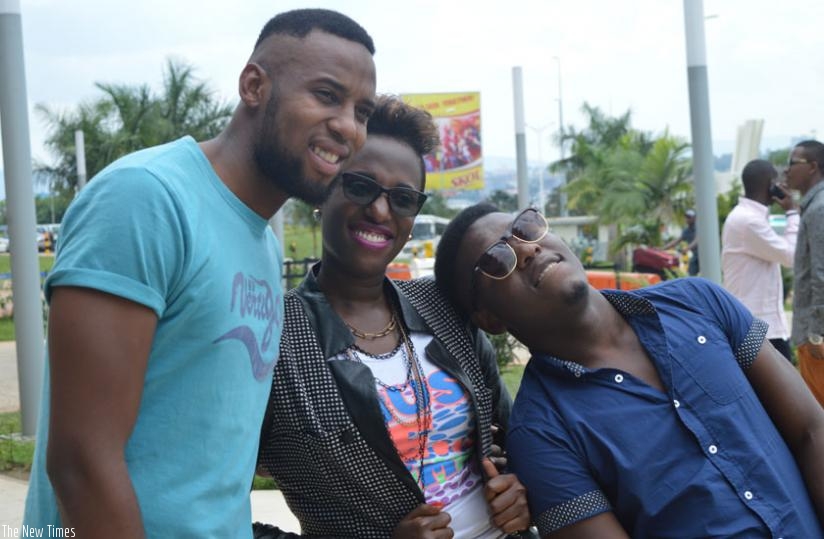 (L-R) Nhlanhla and Permithias pose for a photo with one of their Rwandan fans.