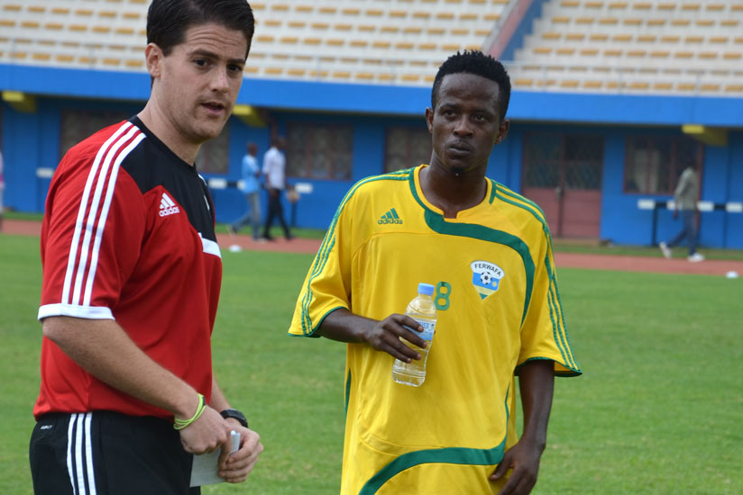 Amavubi head coach McKinstry shares a word with his team captain Haruna Niyonzima in between a Tuesday's training session at Amahoro National Stadium.