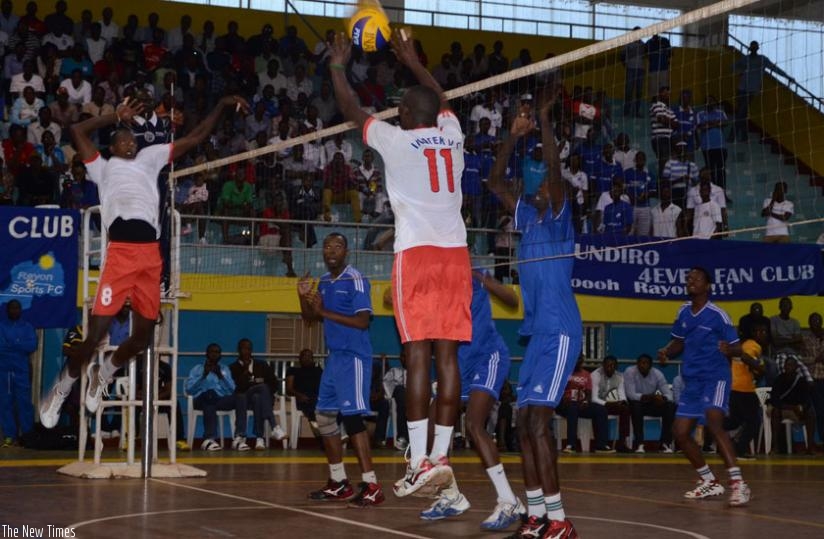 Rayon Sports players prepare to block the ball from Inatek players as both teams clashed on saturday in the national volleyball league. (Sam Ngendihimana)