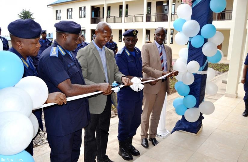 IGP Gasana (2nd L) and Harerimana (2nd right) cut the tape to inaugurate he u2018CID Schoolu2019 yesterday. (Courtesy)