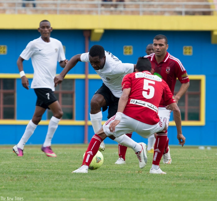Albert Ngabonziza of APR (L) takes on Al Ahly SC defenders during the 2015 Orange Champions League at Amahoro Stadium where APR lost 2-0. (T. Kisambira)