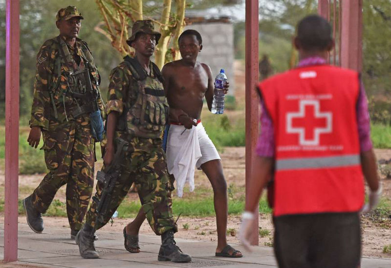A male student hostage is escorted out of Garissa University after Kenya Defense Forces ended a siege by terrorist gunmen on Thursday. 