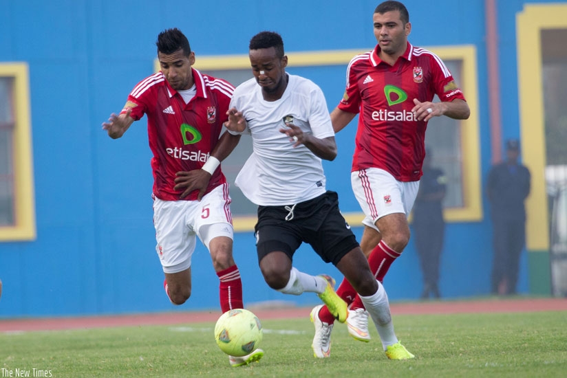 Midfielder Yannick Mukunzi muscles his way past two Al Ahly players during the first leg encounter at Amahoro stadium, which APR lost 0-2 two weeks ago. (Timothy Kisambira)