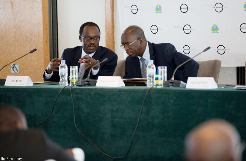 Premier Murekezi (R) consults with Ndayisaba during the workshop in Kigali yesterday. (Timothy Kisambira)