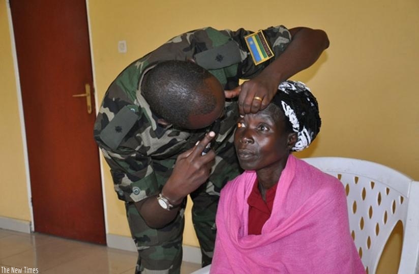 An RDF 2nd Lieutenant treats an eye patient at Gisenyi hospital yesterday.(Thu00e9ogu00e8ne Nsengimana)