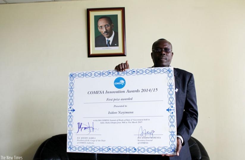Nzeyimana poses with a dummy certificate he received for his innovation. (Courtesy)