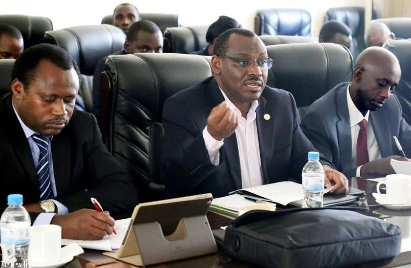 Gatete (C) addresses MPs as Kaboneka (R) and Dr Uziel Ndagijimana, the minister of state for economic planning, look on at Parliament on Wednesday. (John Mbanda)