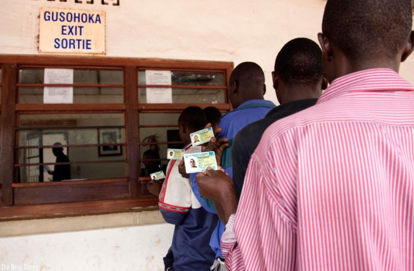 Rwandan nationals travel to Uganda using their identity cards last year. The initiative was introduced to facilitate free movement in the region. (File)