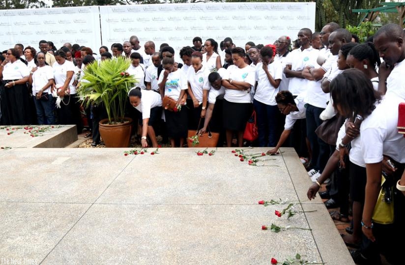 Mourners place roses on a mass grave at Kigali Genocide Memorial Centre, Gisozi, last week, in honour of the victims of the 1994 Genocide against Tutsi. (John Mbanda)