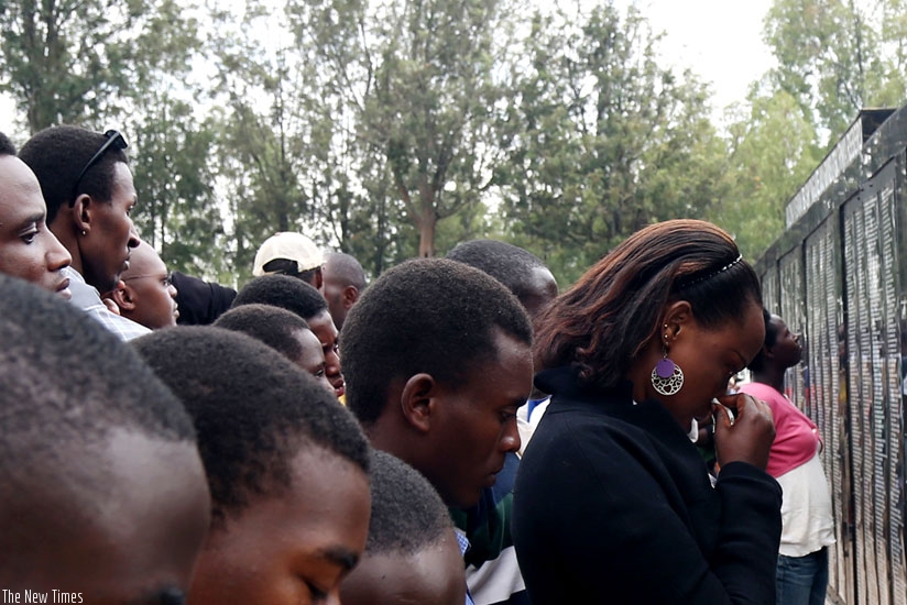 Survivors of the 1994 Genocide against Tutsi are overcome by grief as they read names of the relatives killed in the Genocide at Rebero Genocide Memorial Centre in Kicukiro District on Monday. (John Mbanda)