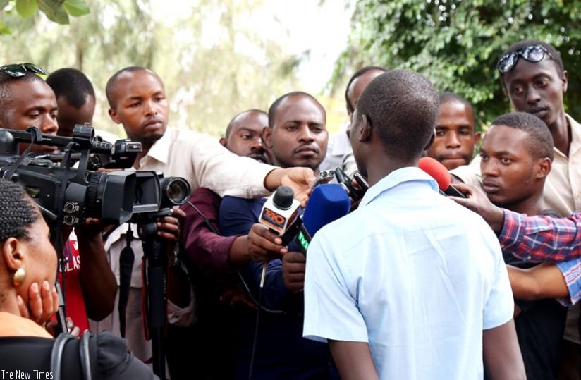 Journalists interview the rescued victim of human trafficking at Police headquarters yesterday. (John Mbanda)