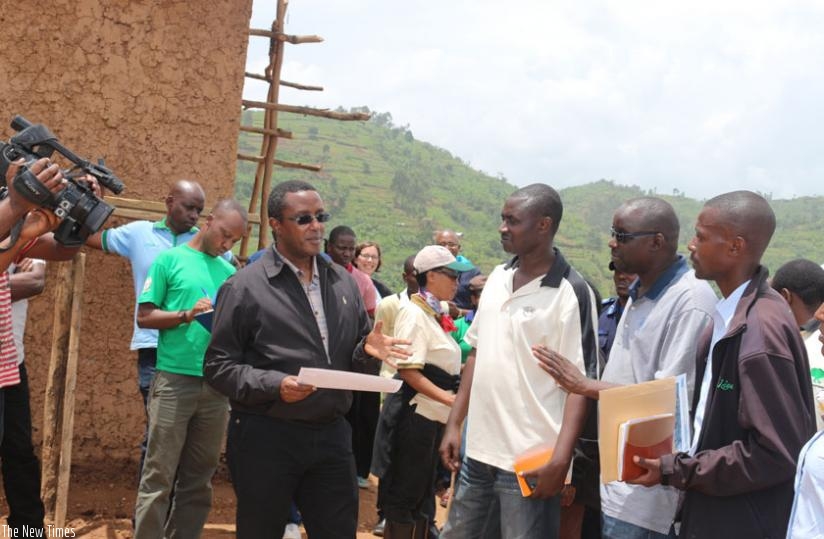 Minister Biruta (right) and other officials at Gashaki site, Musanze district where a model village that will house people living on the islands will be constructed. (Jean d'Amour Mbonyinshuti)