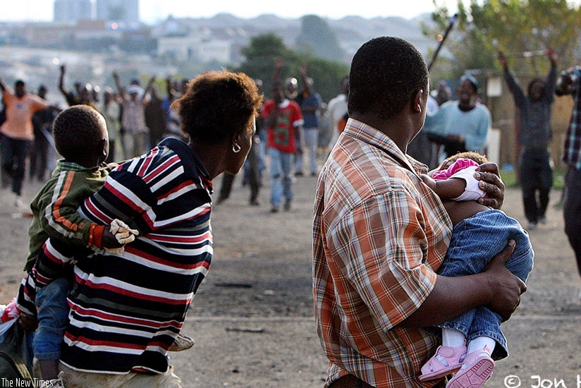 A migrant family leaves their home in a Durban suburb for safety. (Net)