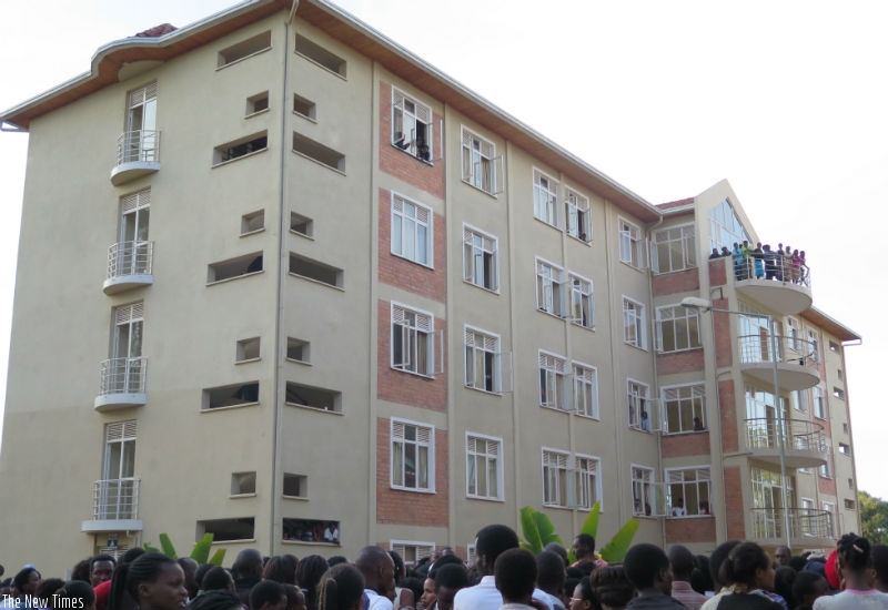 Students stand in front of the female hostel at UR CASS in Huye surveying the damage caused by the fire. Emmanuel Ntirenganya)