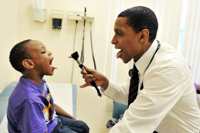 A doctor examines a child. Parents should ensure that their children undergo medical examinations at the end of every holiday. (Dennis Agaba)