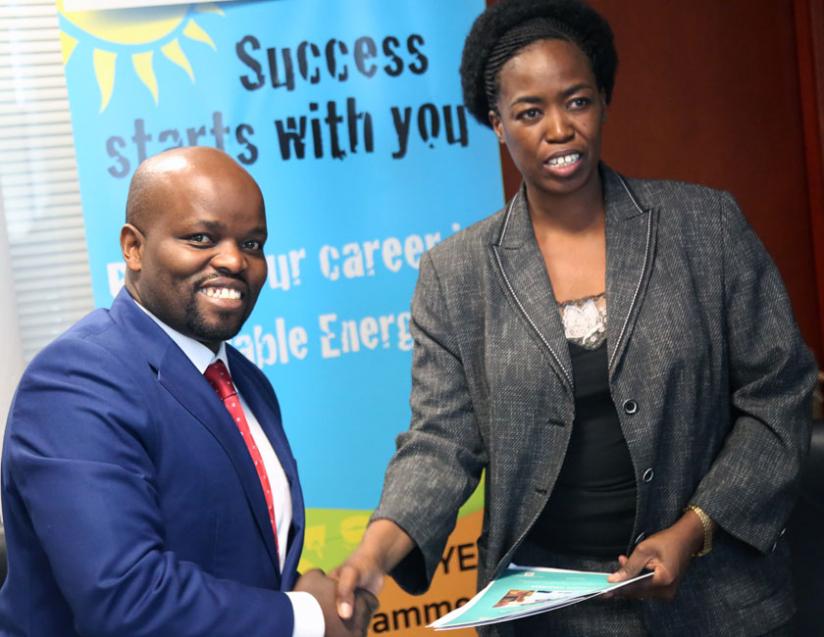 Youth and ICT Minister Jean Philbert Nsengimana (L) shakes hands with SNV Country Director Phomolo Maphosa after signing yesterday. (John Mbanda)