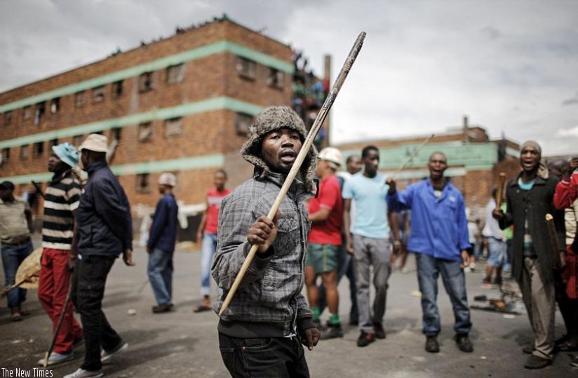 Savage: Rioters armed with sticks, knives and baseball bats attack immigrants in Johannesburg earlier this month. At least seven people have died from the latest wave of xenophobic attacks with thousands others displaced. (Net)