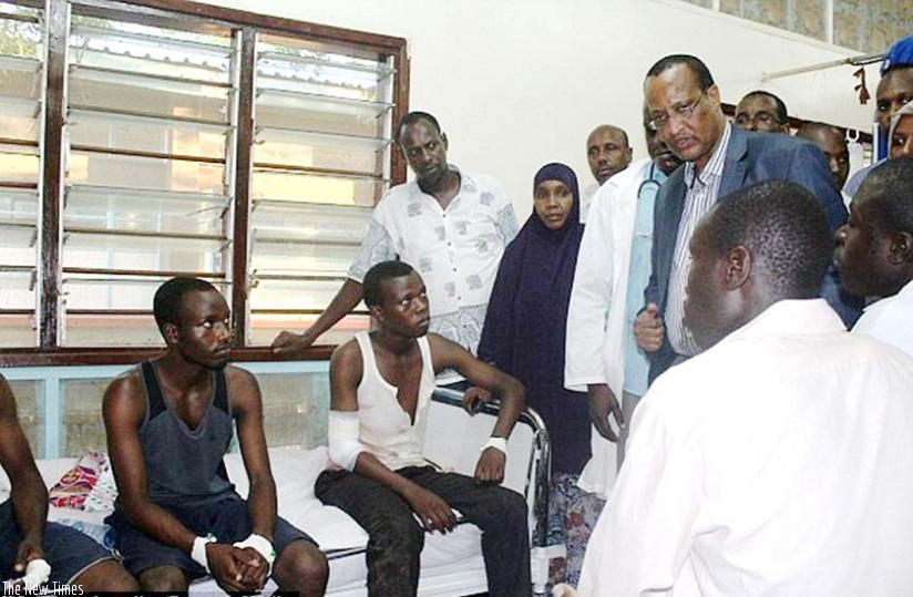 Garissa governor Nathif Jama consoles injured students at a hospital on April 2. (Net)